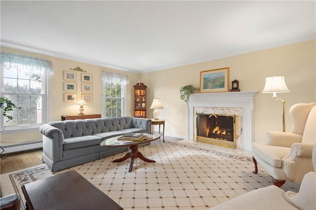 living room with a baseboard radiator, plenty of natural light, a high end fireplace, and light wood-type flooring