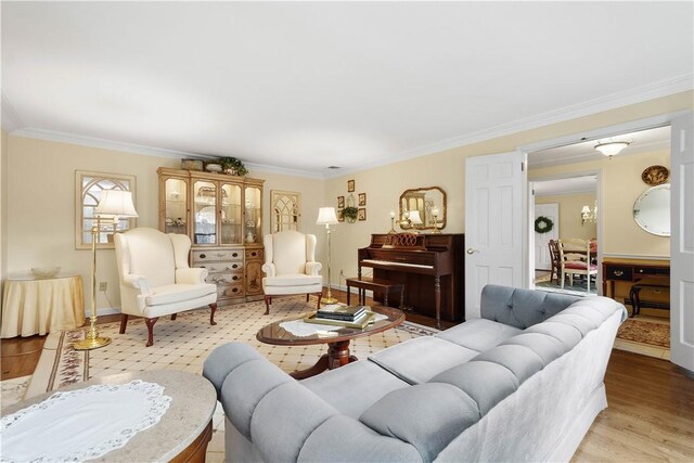 living room featuring light wood-type flooring and ornamental molding