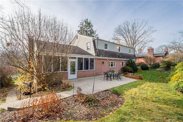 back of property featuring a patio and a yard