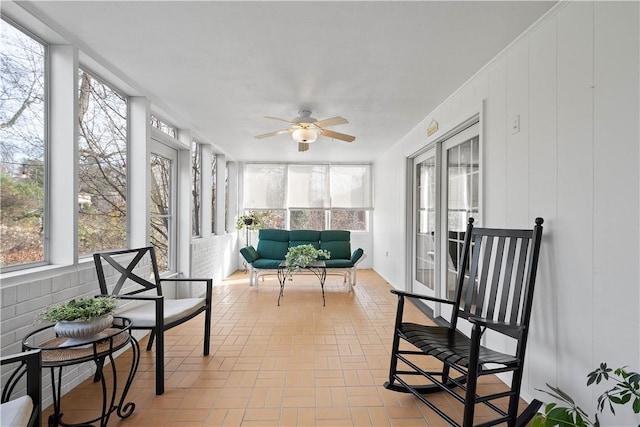 sunroom featuring ceiling fan