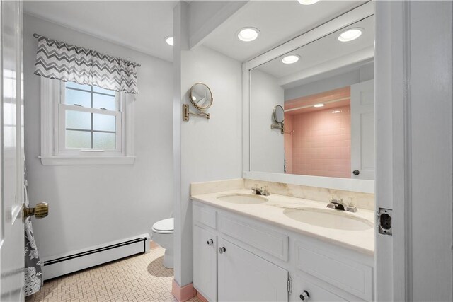 bathroom with tile patterned flooring, vanity, toilet, and a baseboard radiator