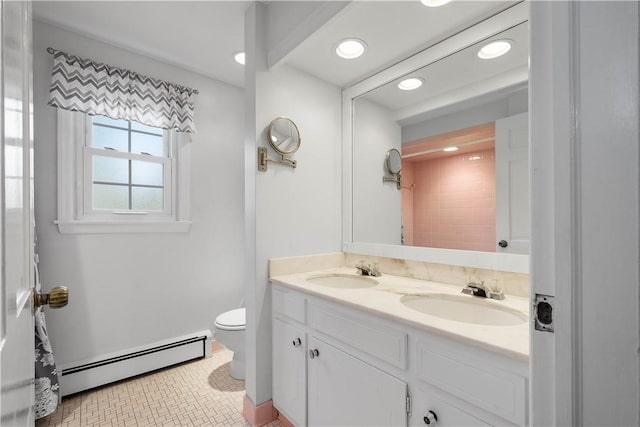 bathroom featuring vanity, toilet, and a baseboard heating unit