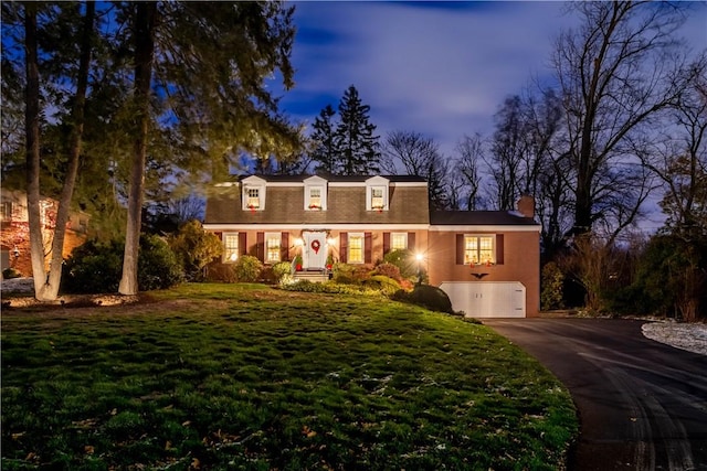 view of front of house featuring a garage and a yard