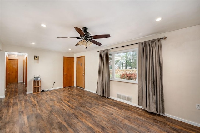 spare room with dark hardwood / wood-style floors and ceiling fan