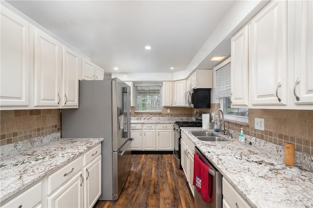 kitchen featuring white cabinets, sink, appliances with stainless steel finishes, a healthy amount of sunlight, and dark hardwood / wood-style flooring