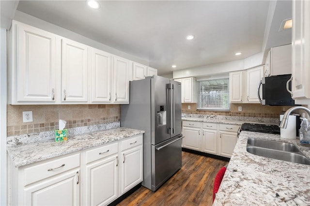 kitchen featuring appliances with stainless steel finishes, dark hardwood / wood-style floors, and white cabinetry