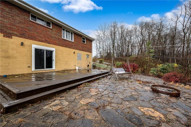 view of patio / terrace with a fire pit and a wooden deck