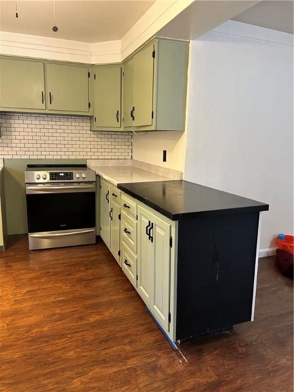 kitchen featuring dark hardwood / wood-style floors, backsplash, and stainless steel range