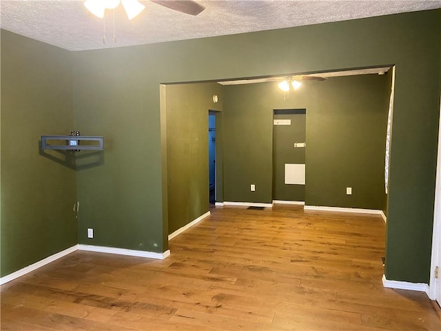 entryway with wood-type flooring, a textured ceiling, and ceiling fan