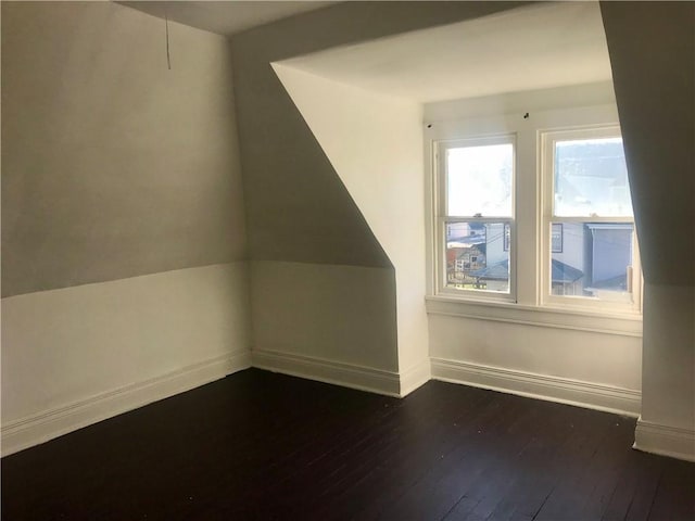 additional living space featuring dark wood-type flooring