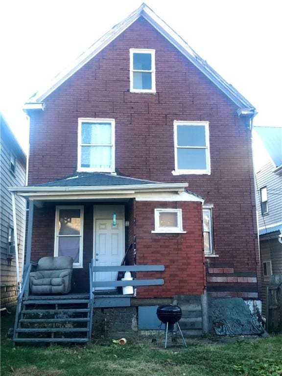 back of property with a porch