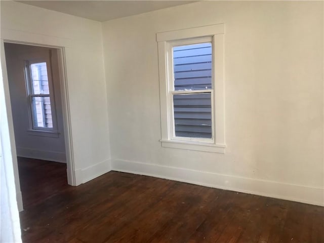 unfurnished room with dark hardwood / wood-style floors