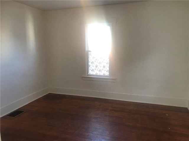 unfurnished room featuring dark hardwood / wood-style floors