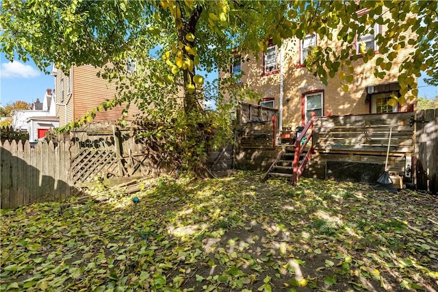 view of yard with a wooden deck and fence