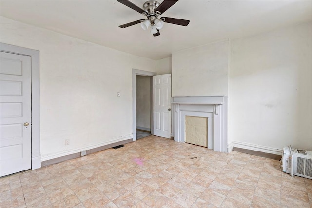 unfurnished living room with baseboards, a ceiling fan, and visible vents
