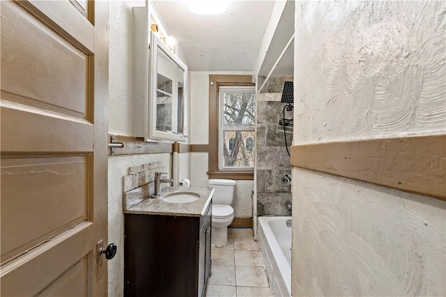 bathroom with tile patterned flooring, toilet, bathtub / shower combination, and vanity