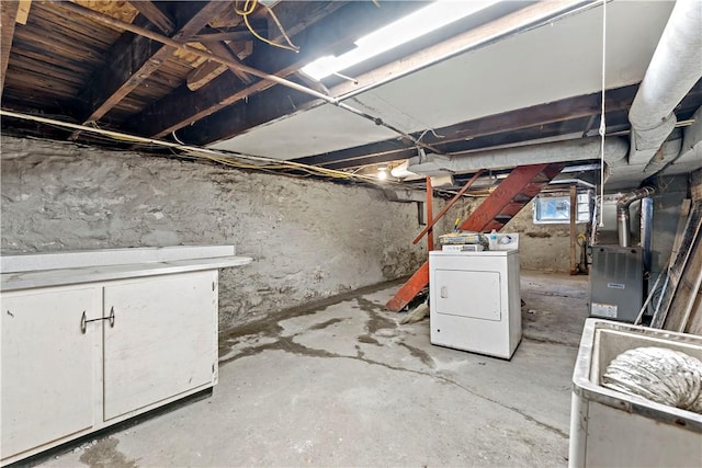 below grade area with washer / clothes dryer and heating unit