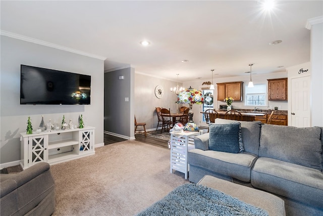 living room with hardwood / wood-style flooring, a notable chandelier, and ornamental molding