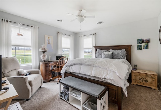 bedroom with carpet flooring, multiple windows, and ceiling fan