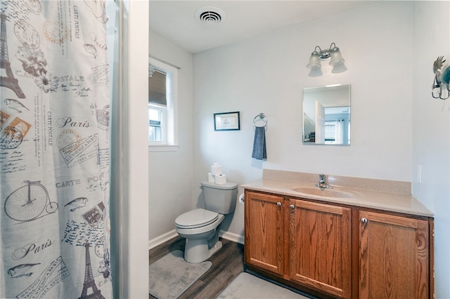 bathroom featuring toilet, vanity, and hardwood / wood-style flooring