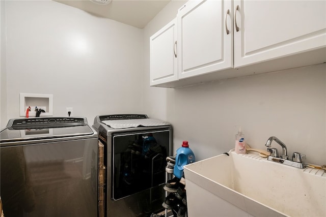 washroom featuring cabinets, washer and dryer, and sink