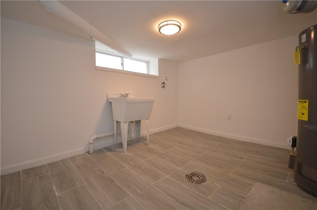 clothes washing area featuring water heater