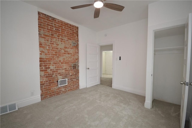 unfurnished bedroom with ceiling fan, light carpet, and a closet