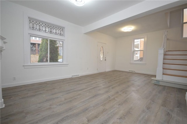 unfurnished living room featuring wood-type flooring