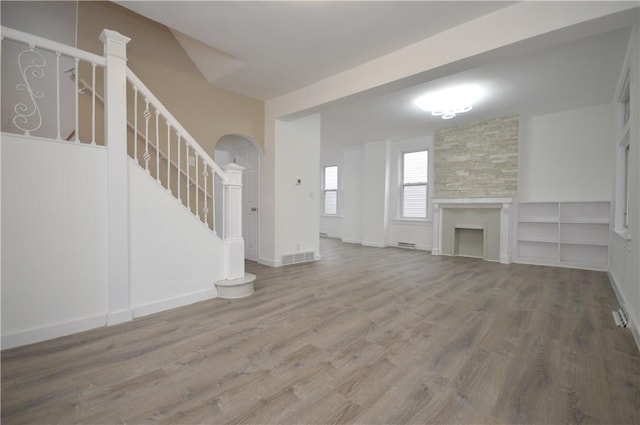 unfurnished living room with hardwood / wood-style floors and a fireplace