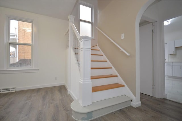 staircase with wood-type flooring