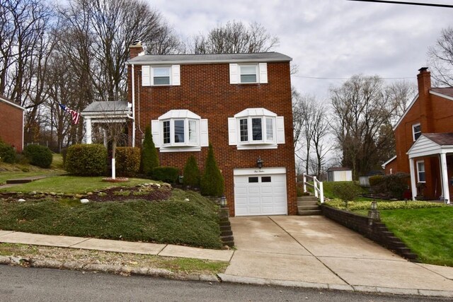 view of front of house with a front yard and a garage