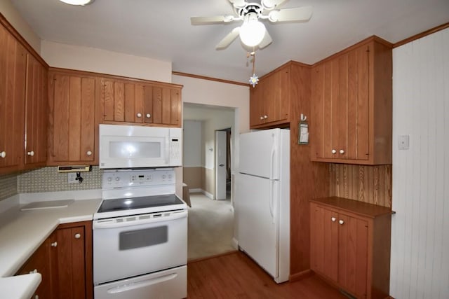 kitchen featuring ceiling fan, white appliances, backsplash, and light wood-type flooring