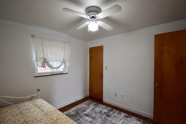 bedroom featuring dark hardwood / wood-style flooring and ceiling fan