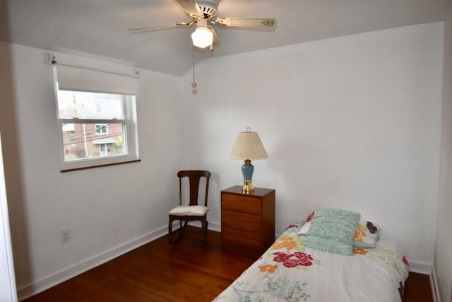 bedroom featuring vaulted ceiling, dark hardwood / wood-style floors, and ceiling fan