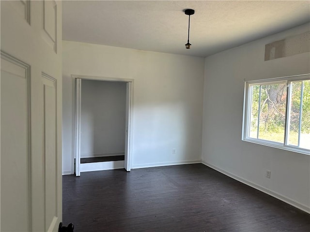 spare room with dark hardwood / wood-style flooring