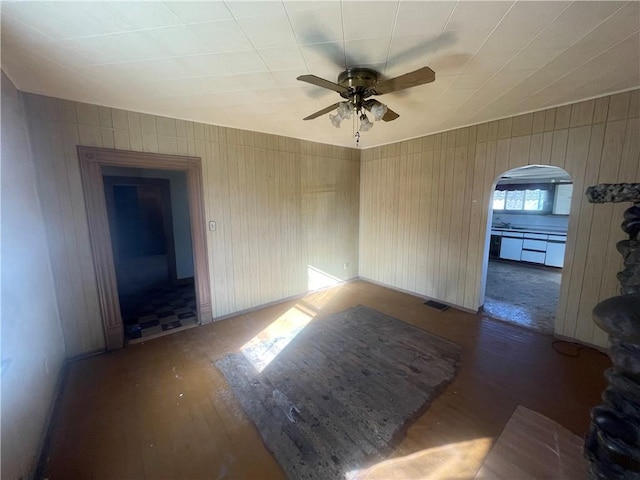 empty room featuring ceiling fan and dark hardwood / wood-style flooring