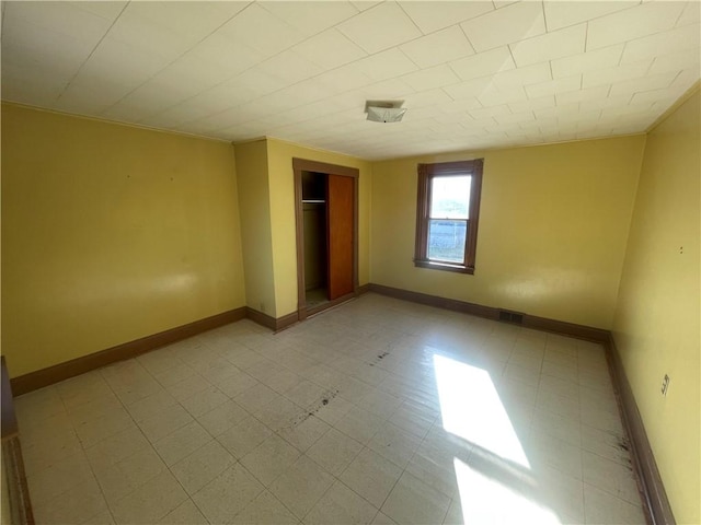 unfurnished bedroom featuring a closet and ornamental molding