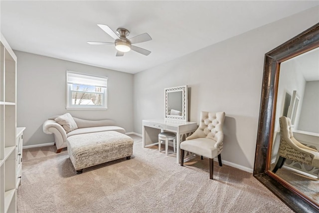 living area with carpet and ceiling fan