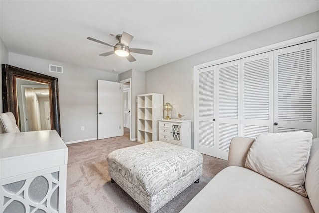 carpeted bedroom with a closet and ceiling fan