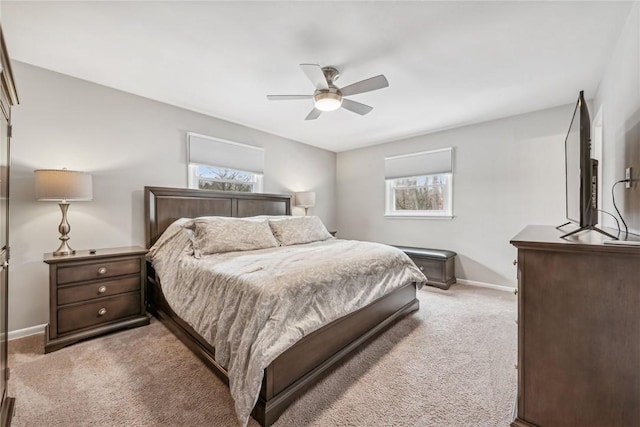 carpeted bedroom featuring ceiling fan and multiple windows