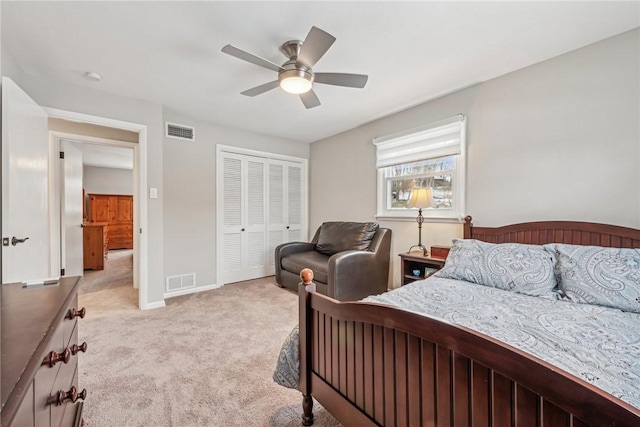 bedroom featuring ceiling fan, a closet, and light carpet