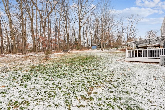 snowy yard with a deck