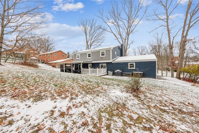 view of snow covered rear of property