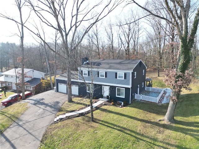 front facade featuring a garage and a front lawn