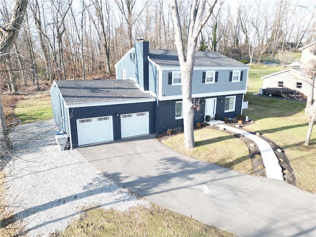 view of front of home with a front yard and a garage