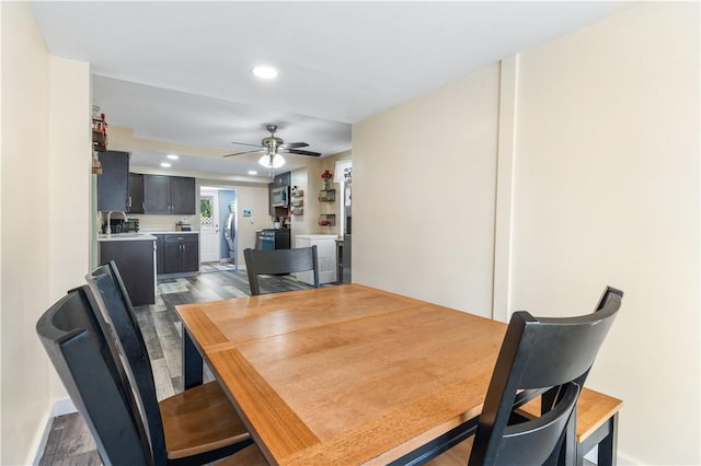 dining room with ceiling fan, dark wood-type flooring, and sink