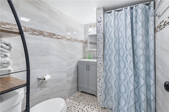 bathroom with a shower with curtain, toilet, tile walls, and vanity