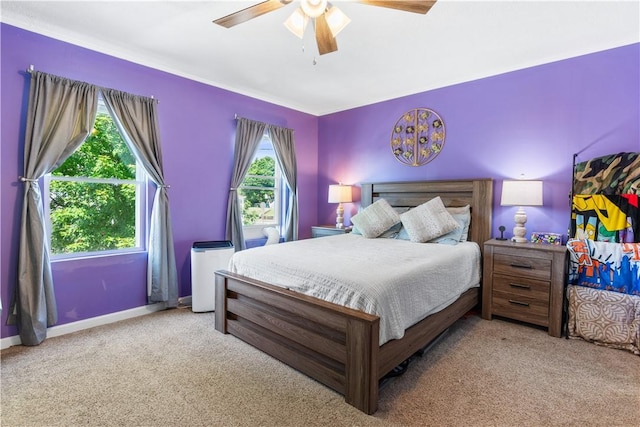 carpeted bedroom with multiple windows and ceiling fan