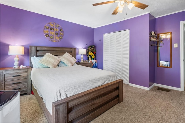 carpeted bedroom featuring a closet, ceiling fan, and crown molding