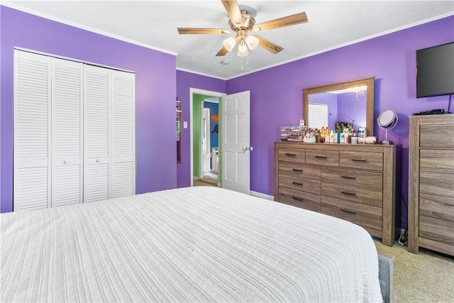 bedroom featuring crown molding, ceiling fan, a closet, and light colored carpet